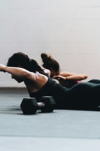 two woman stretching in a pilates class.