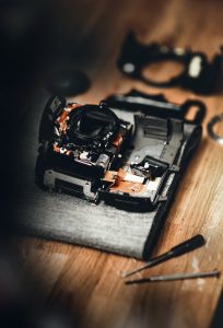 a damaged camera taken apart for repair.