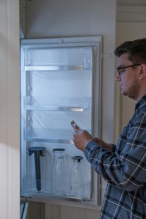 person looking at the inside of a fridge.