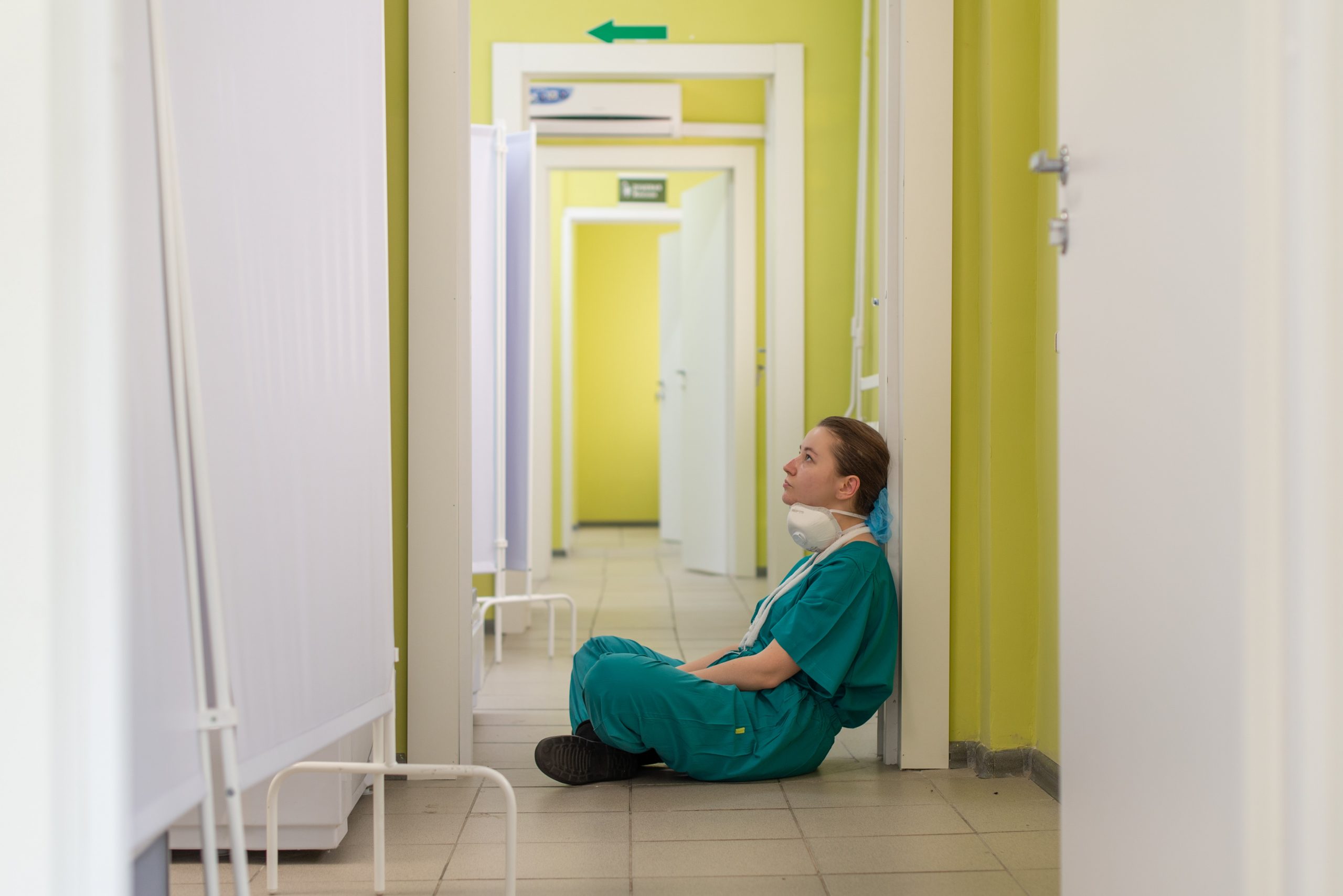Healthcare staff decompresses in hallway.
