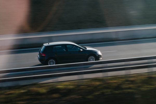 A single car driving down the highway